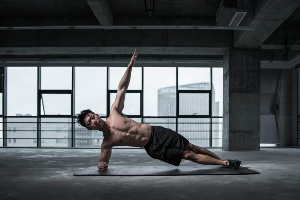 person doing bodyweight workout exercise name side plank